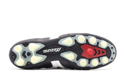 Mizuno Morelia MD FG/AG in the Black/White/Red colorway, photographed from the bottom side of the football boot, showing the soleplate