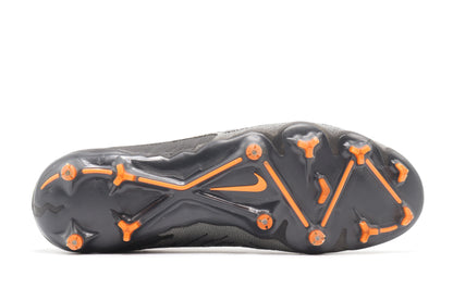 Nike Phantom GX Elite FG, in the Black/Summit White/Dark Smoke Grey colorway, photographed from the bottom side of the football boot, showing the soleplate